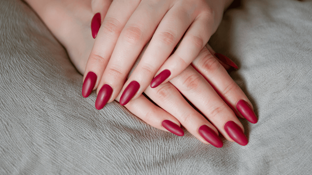 Close-up of flawless red matte CND Shellac nails, showcasing salon-quality results at Director’s Cut Hairdressing in Crystal Peaks, Sheffield.