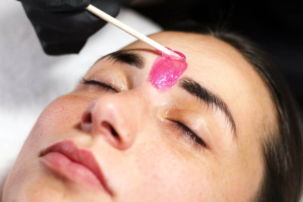 Professional eyebrow waxing with pink wax at Director’s Cut Hairdressing, Nails & Beauty in Crystal Peaks, Sheffield.