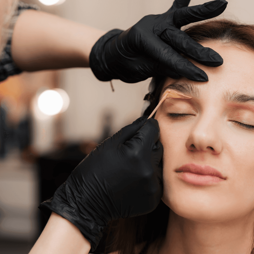Client receiving gentle eyebrow waxing at Director’s Cut salon in Crystal Peaks, Sheffield.