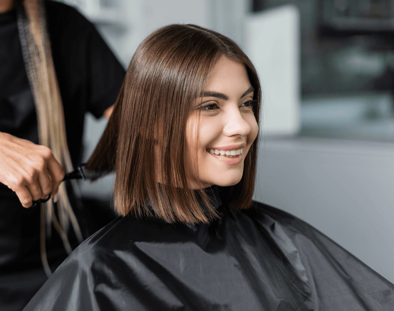 Smiling woman receiving a professional wet cut at Directors Cut Hair, Nails and Beauty, Crystal Peaks, Sheffield