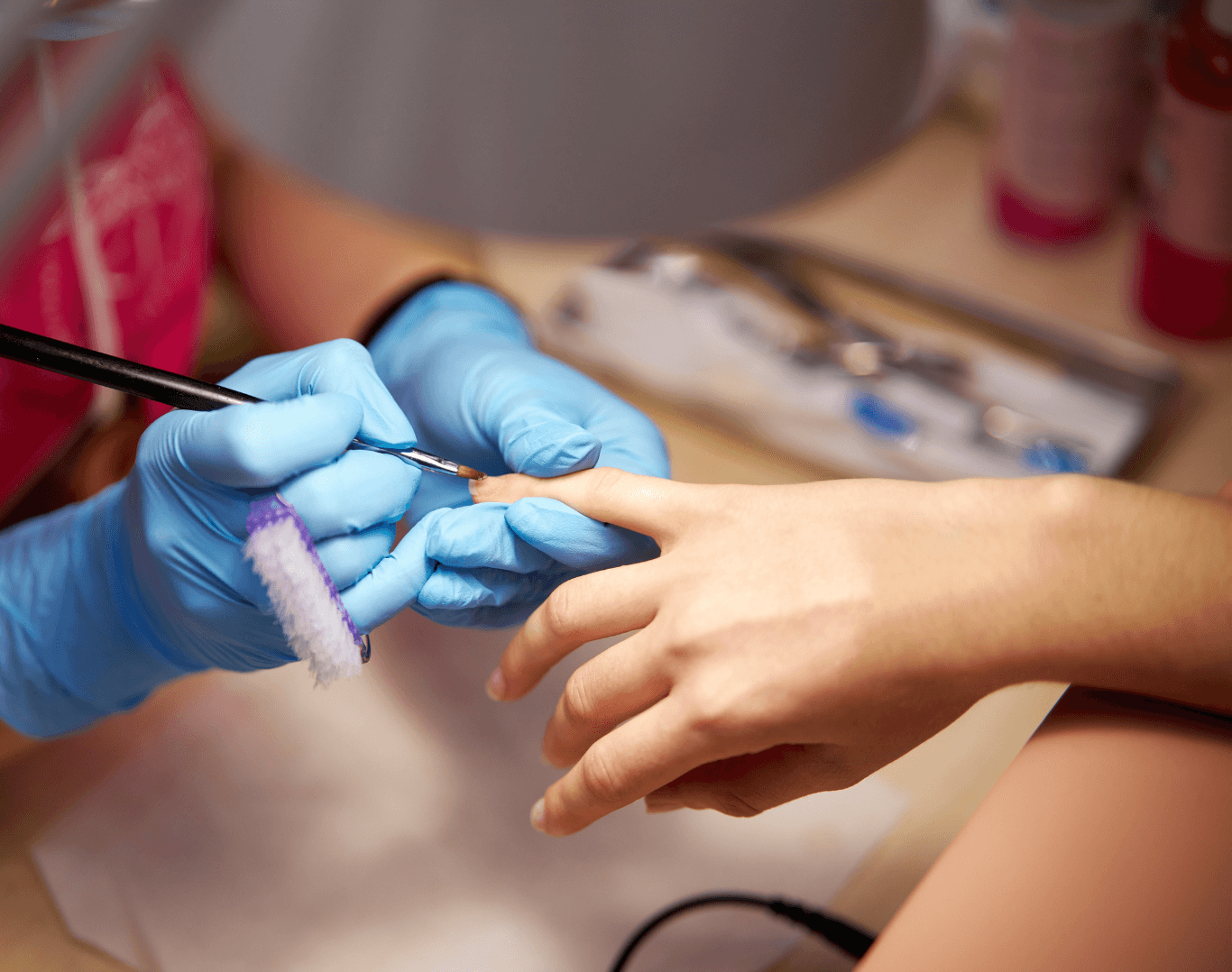 Nail technician applying infills to maintain acrylic or gel nails at Directors Cut Hair, Nails and Beauty, Crystal Peaks, Sheffield