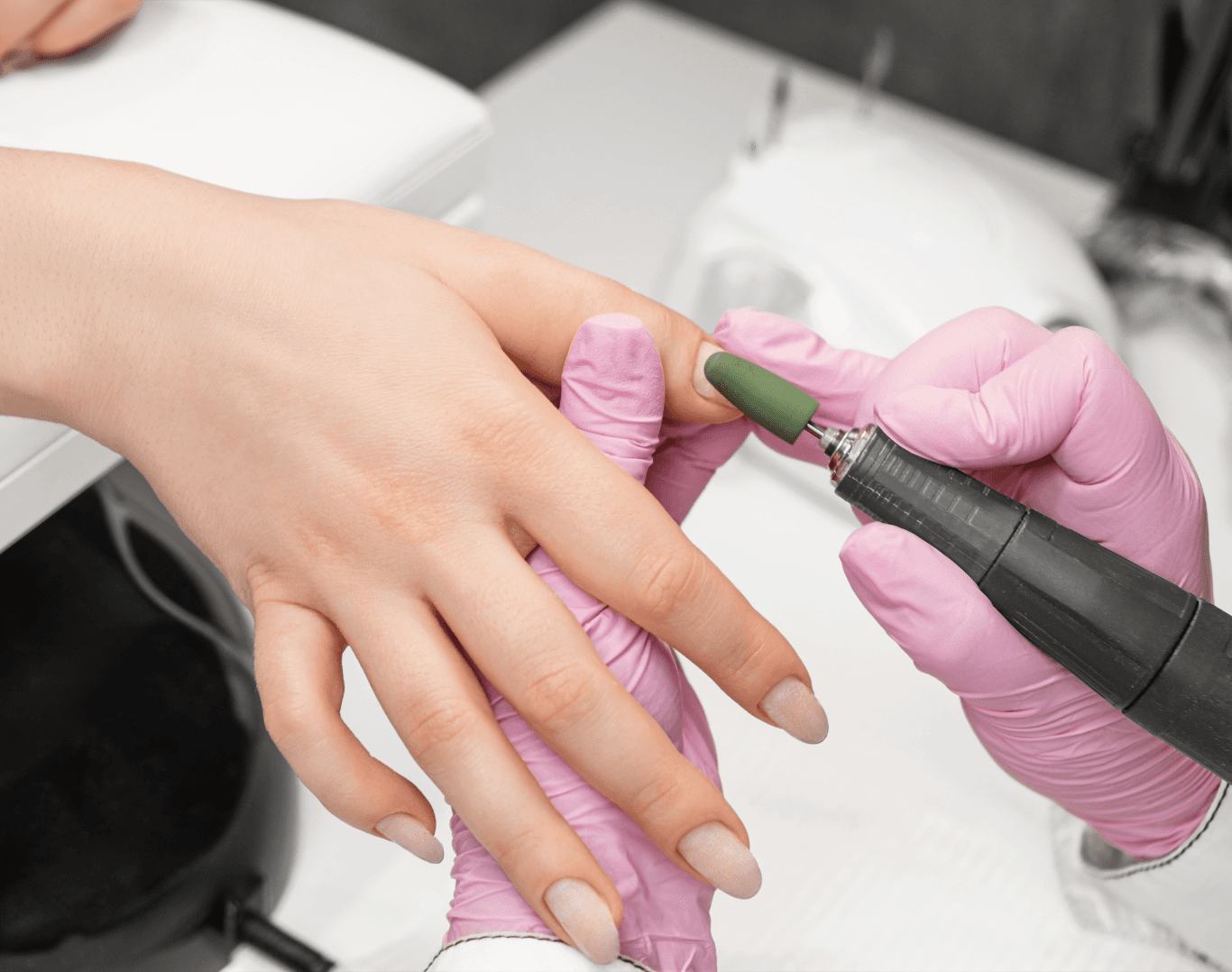 Technician performing a professional nail repair with electric tool at Directors Cut Hair, Nails and Beauty, Crystal Peaks, Sheffield